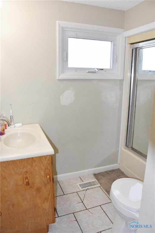 full bathroom with tile patterned flooring, vanity, toilet, and enclosed tub / shower combo