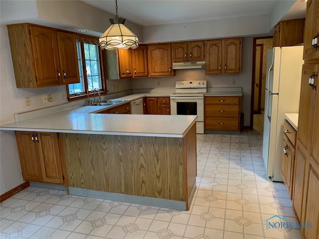 kitchen featuring white appliances, kitchen peninsula, sink, and pendant lighting