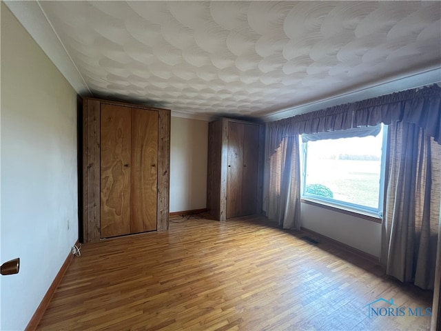 unfurnished bedroom with light hardwood / wood-style flooring