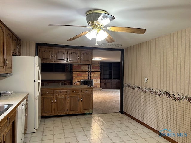 kitchen featuring white dishwasher, ceiling fan, and light colored carpet