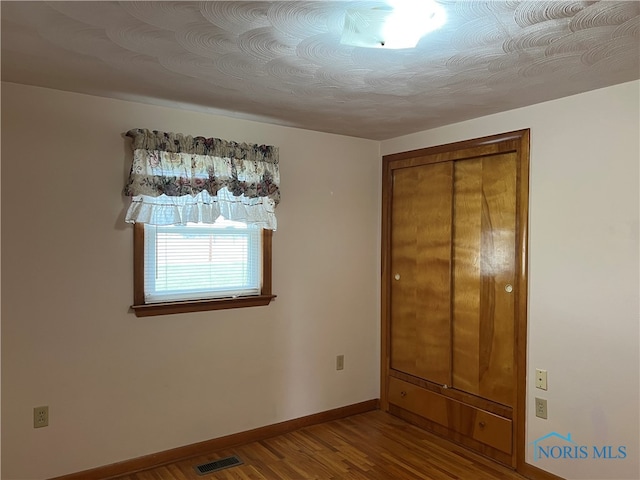 unfurnished bedroom featuring hardwood / wood-style floors