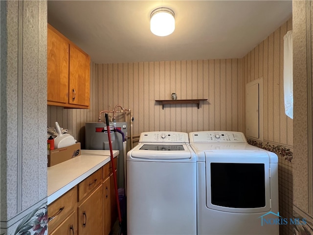 clothes washing area featuring cabinets and washing machine and clothes dryer