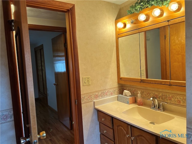 bathroom featuring hardwood / wood-style flooring and vanity