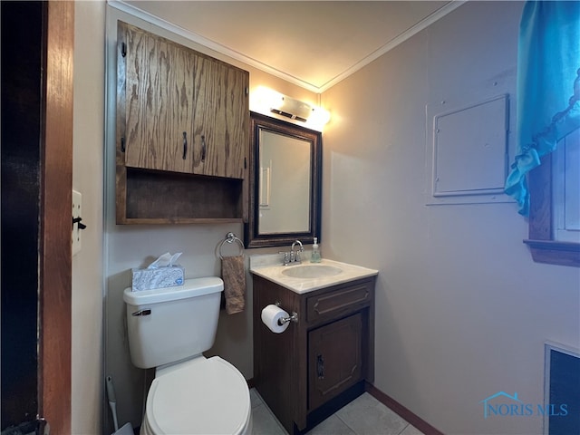 bathroom featuring tile patterned flooring, vanity, toilet, and crown molding