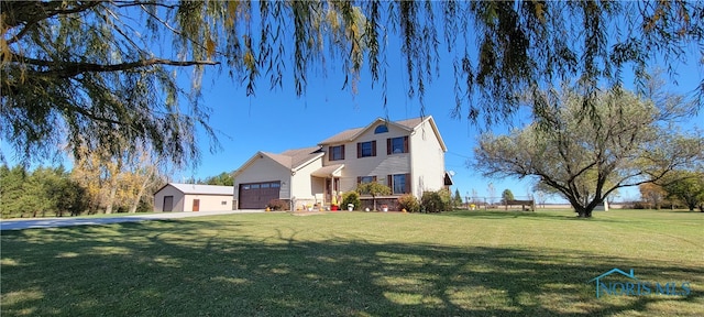 view of front facade with a front yard and a garage