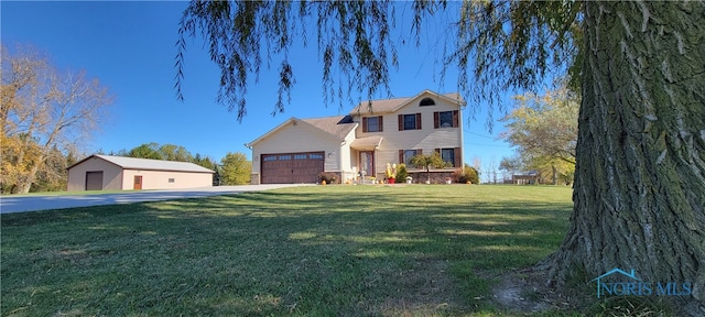 view of front of house with a front yard and a garage