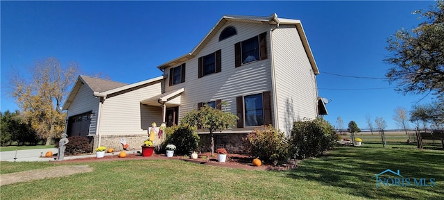 view of front of home with a garage and a front lawn