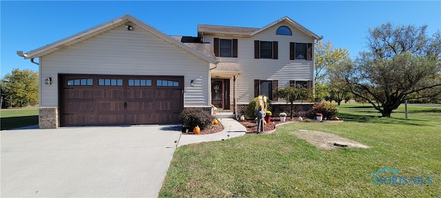 view of front of home with a front yard and a garage