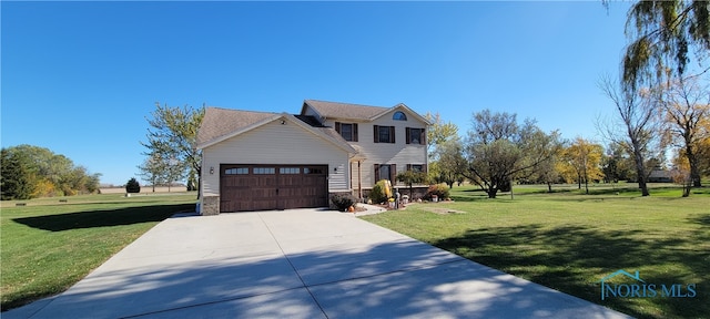 view of front of home featuring a front lawn and a garage