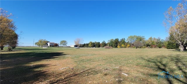 view of yard with a rural view