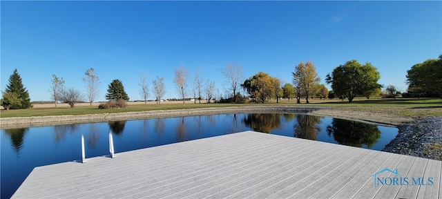 dock area featuring a water view and a lawn