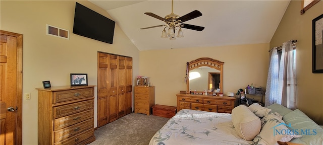 carpeted bedroom with a closet, ceiling fan, and vaulted ceiling