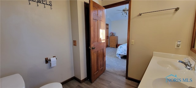 bathroom with vanity, toilet, hardwood / wood-style flooring, and ceiling fan