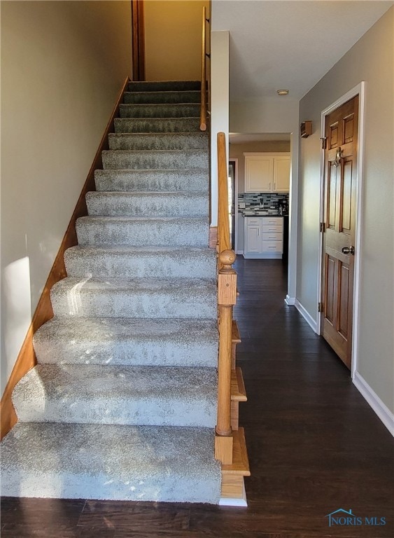 staircase featuring hardwood / wood-style flooring