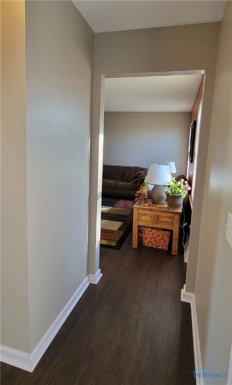 hallway with dark wood-type flooring