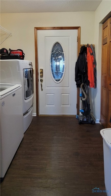 laundry room with independent washer and dryer and dark hardwood / wood-style floors