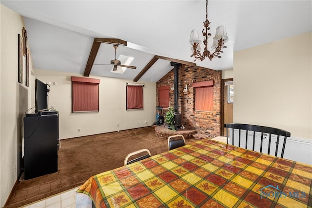 dining space with carpet, brick wall, ceiling fan with notable chandelier, lofted ceiling with beams, and a wood stove