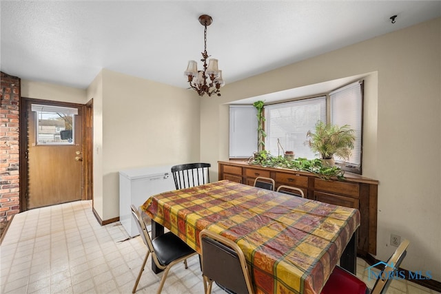 dining area featuring an inviting chandelier