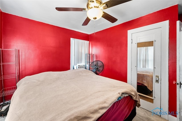 bedroom featuring ceiling fan and carpet