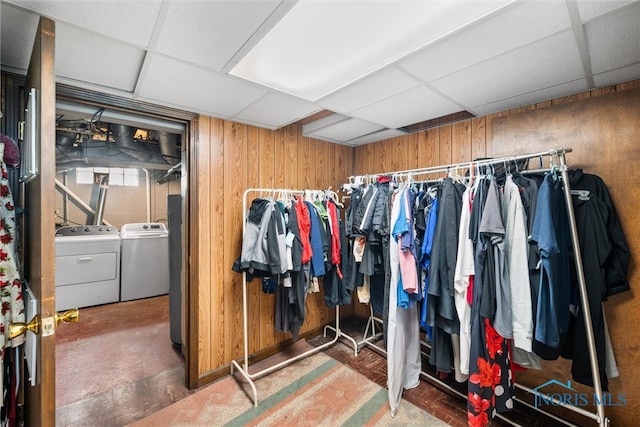 spacious closet with a paneled ceiling and washing machine and clothes dryer