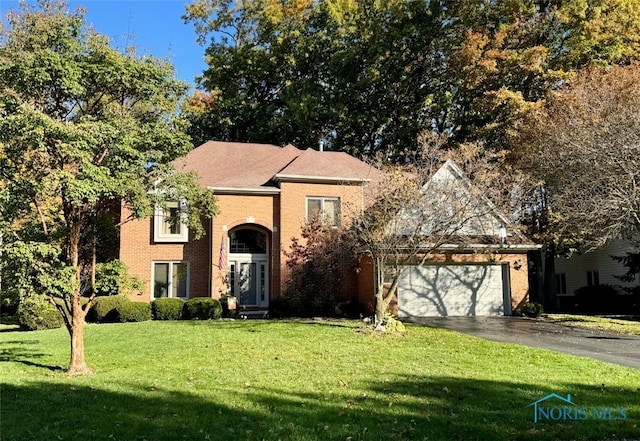 front facade with a garage and a front yard