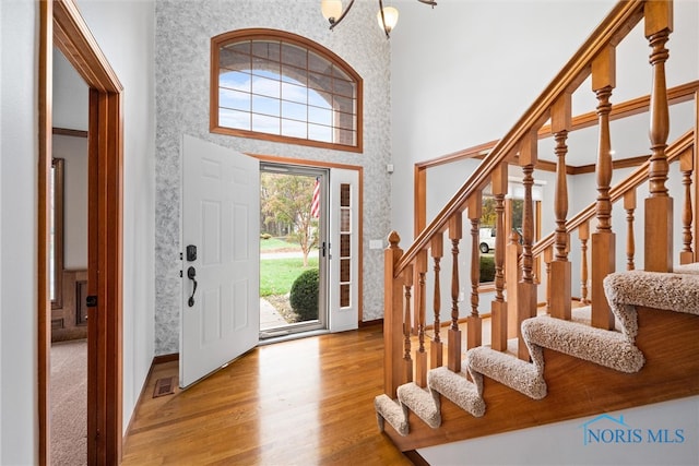 entrance foyer featuring light hardwood / wood-style floors and a high ceiling