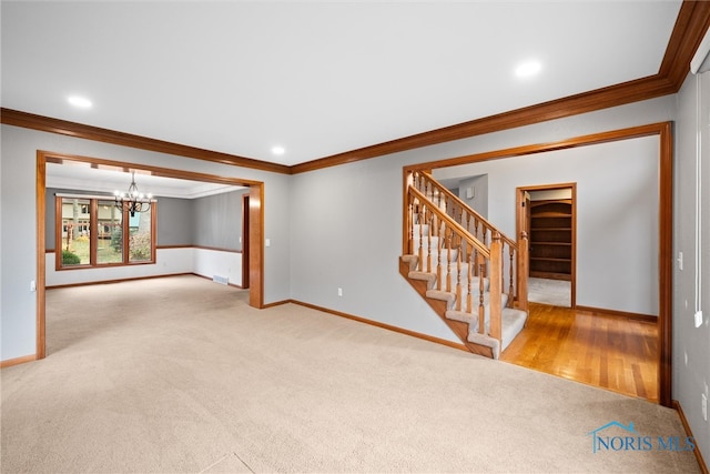 carpeted empty room with an inviting chandelier and ornamental molding