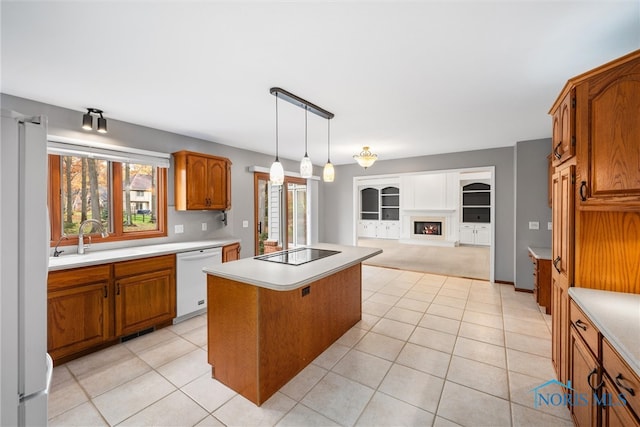 kitchen featuring sink, light tile patterned flooring, a kitchen island, pendant lighting, and white appliances