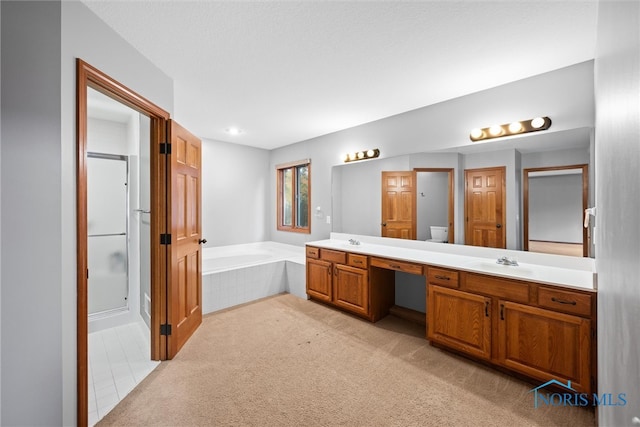 full bathroom featuring toilet, vanity, and separate shower and tub