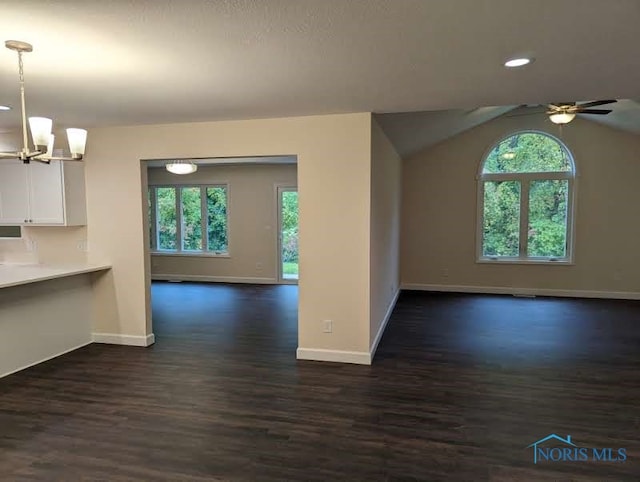 interior space featuring lofted ceiling, a wealth of natural light, and dark hardwood / wood-style flooring