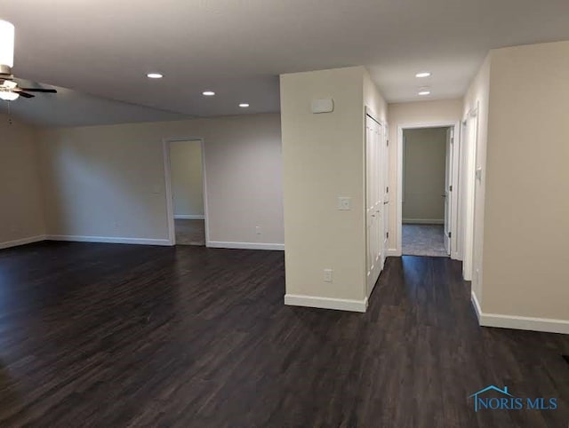 spare room featuring dark wood-type flooring and ceiling fan