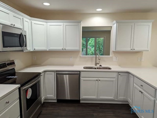 kitchen featuring white cabinetry, stainless steel appliances, sink, and dark hardwood / wood-style floors