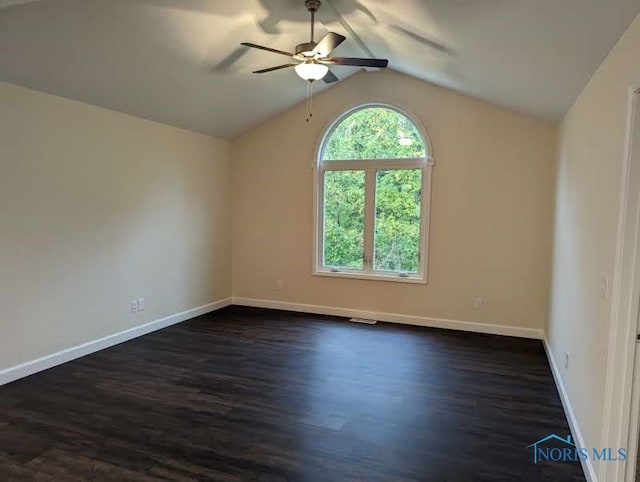 empty room with ceiling fan, plenty of natural light, and dark hardwood / wood-style floors