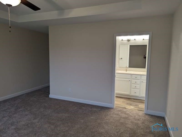 carpeted empty room featuring sink and ceiling fan