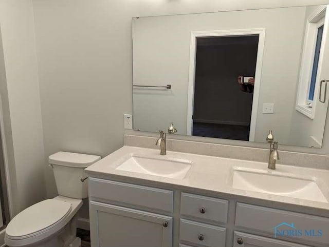 bathroom with vanity and toilet