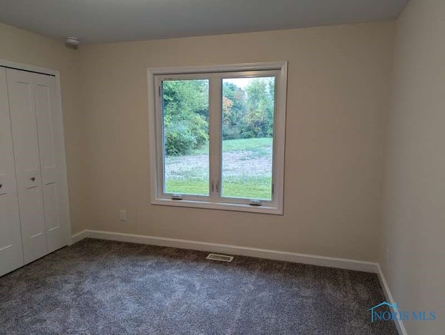 unfurnished bedroom with carpet and a closet