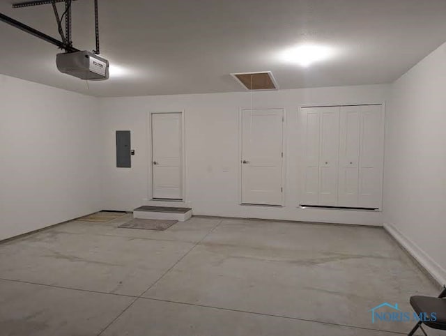 garage with a garage door opener and electric panel