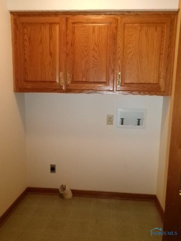 laundry area with electric dryer hookup, washer hookup, and cabinets