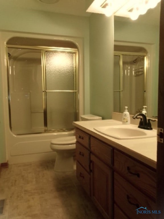 full bathroom with vanity, toilet, and enclosed tub / shower combo