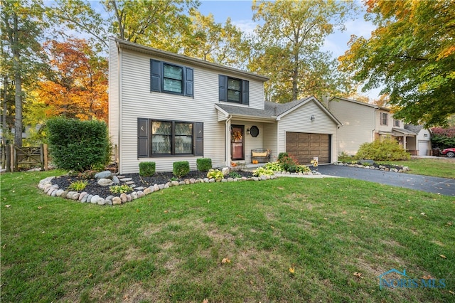 front facade with a garage and a front yard