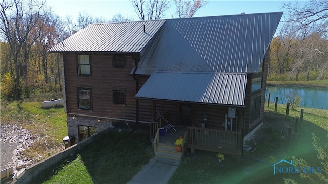 back of property with a water view