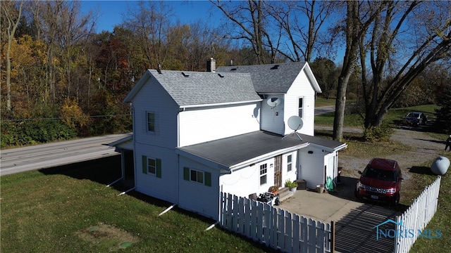 back of property featuring a yard