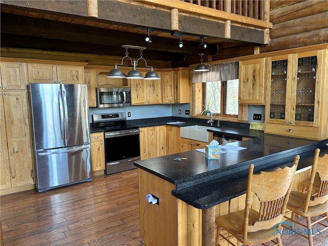 kitchen featuring sink, beamed ceiling, dark hardwood / wood-style floors, pendant lighting, and appliances with stainless steel finishes