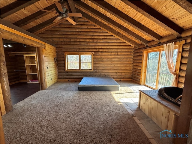 unfurnished bedroom with multiple windows, rustic walls, and wood ceiling