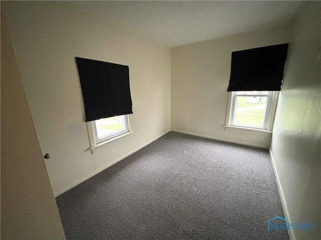 empty room with plenty of natural light and carpet floors