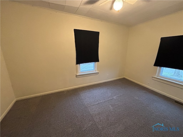 carpeted empty room featuring ceiling fan and crown molding