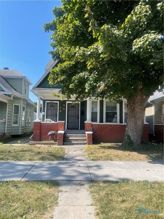 obstructed view of property with a porch