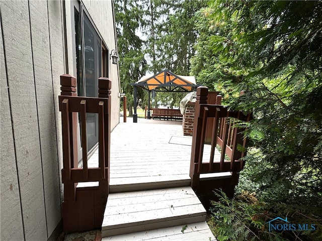 wooden terrace featuring a gazebo