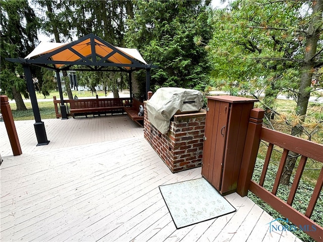 wooden deck featuring a gazebo and a grill