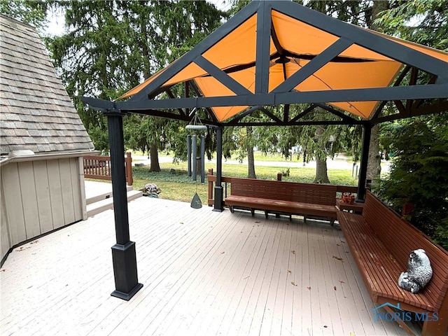 wooden terrace featuring a gazebo